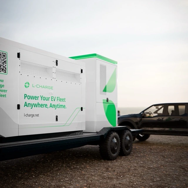 L-Charge trailer alongside EV charging